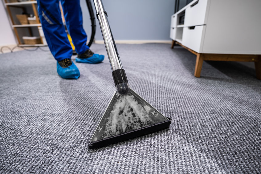 Close-up Of A Cleaning Carpet With Vacuum Cleaner