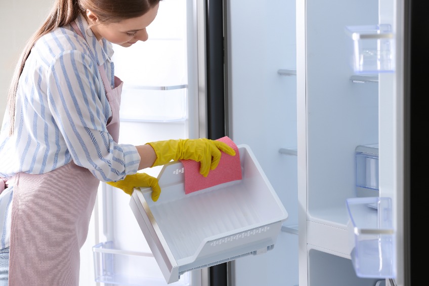 a woman cleaning refrigerator